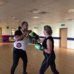 person-trainer-doing-boxing-training-with-customer